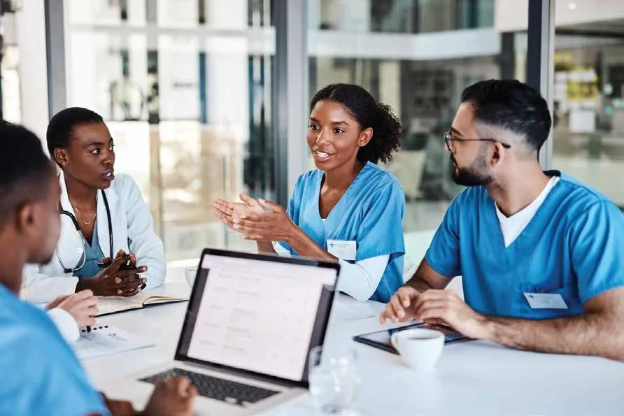 Doctors and nurses meeting to discuss patient care and coordinate treatment plans in a hospital
